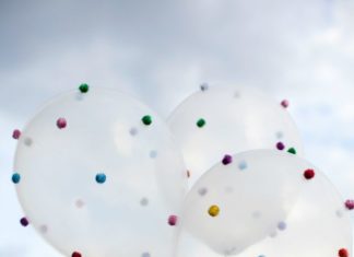 Birthday Decoration : Hot glue pom poms to balloons!