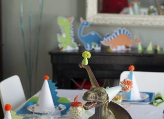 Birthday Inspiration: Jurassic World Birthday Party Ideas; party hats on dinosaurs table