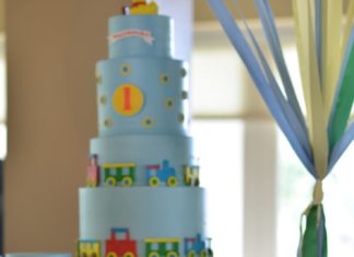 Birthday Party Inspiration : A multitiered baby-blue-frosted birthday cake was custom made with colorful trai…